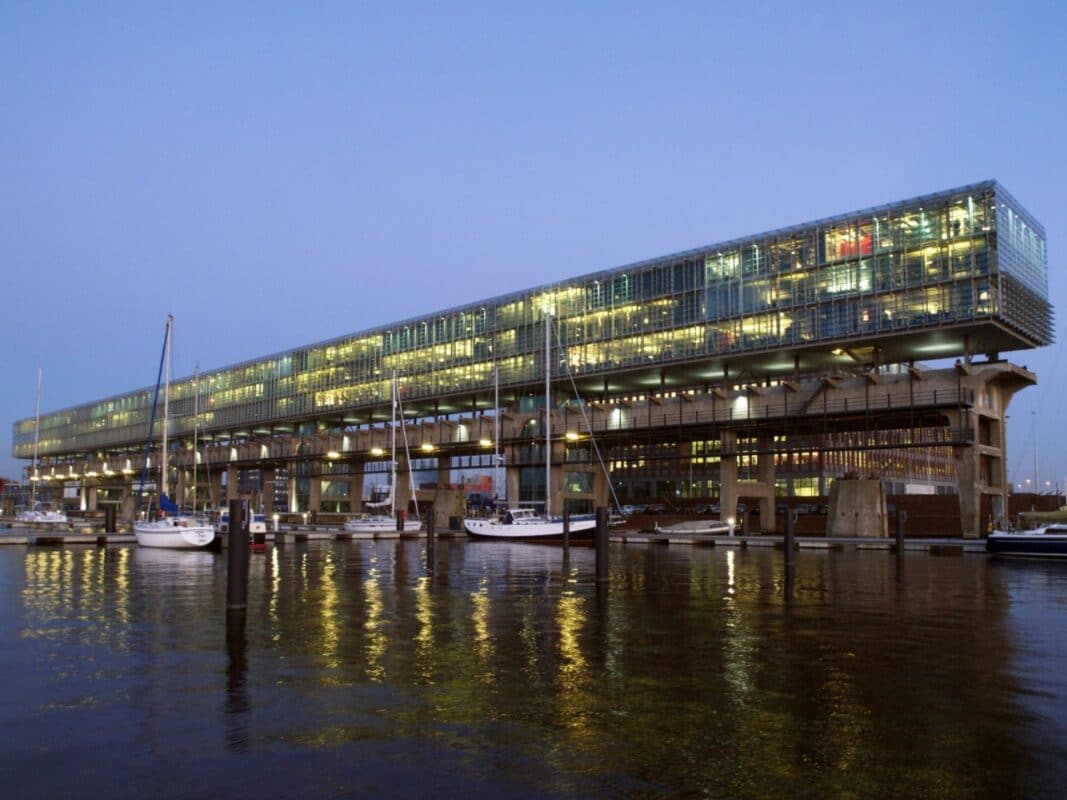 The former crane track building on the IJ in Amsterdam at night